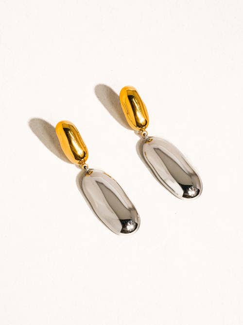 Gold and silver earrings on a white background