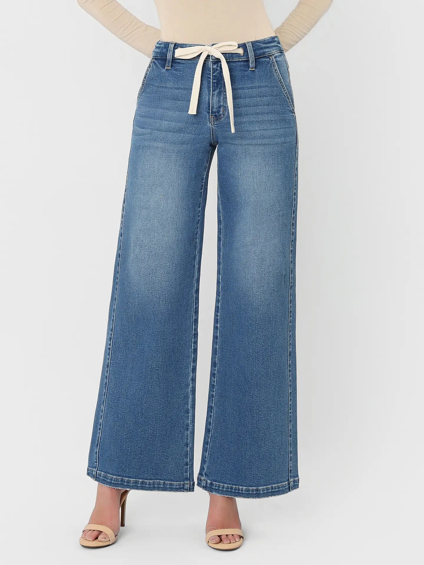 Blue wide-leg jeans with a tie waist on a white background