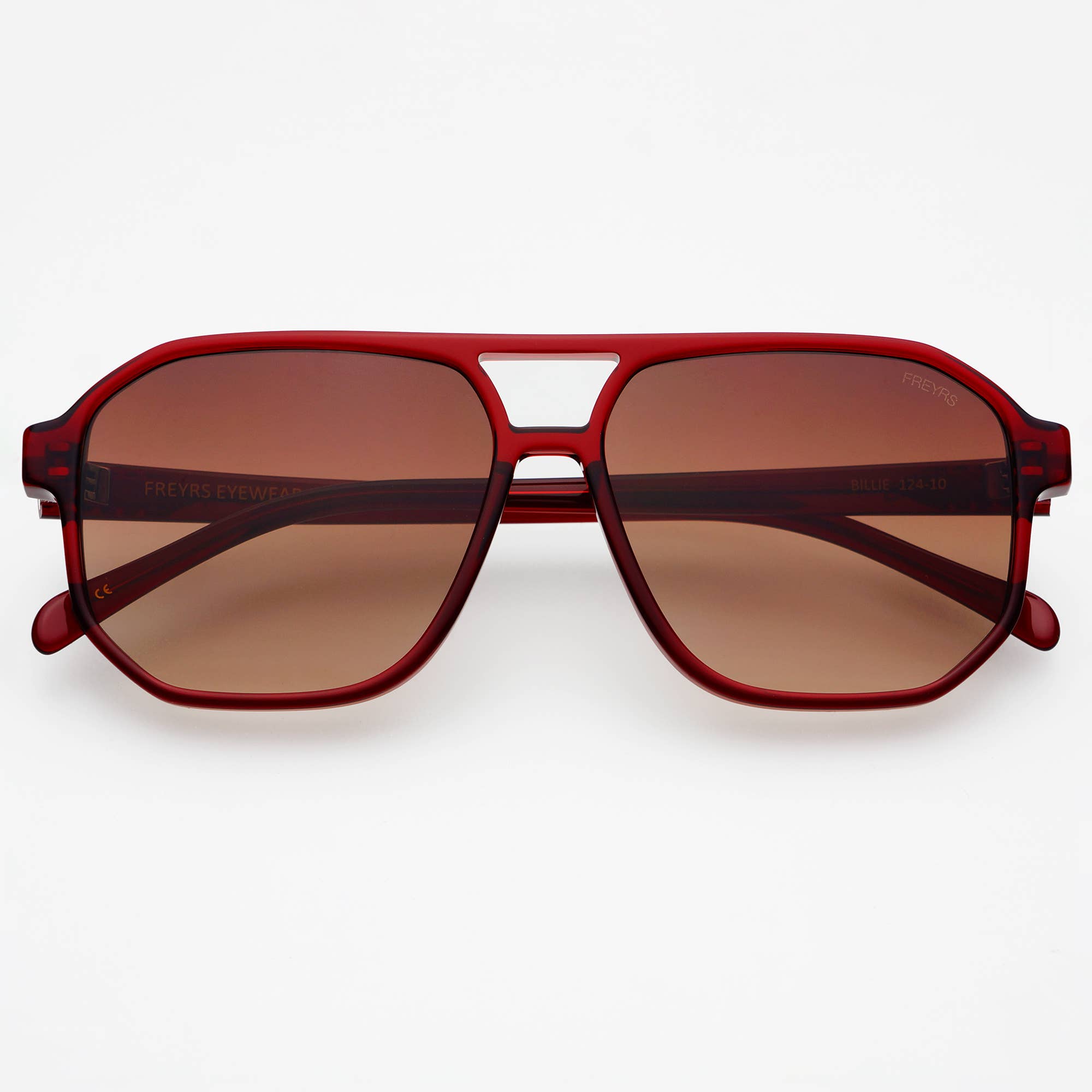 Red sunglasses with brown lenses on a white background