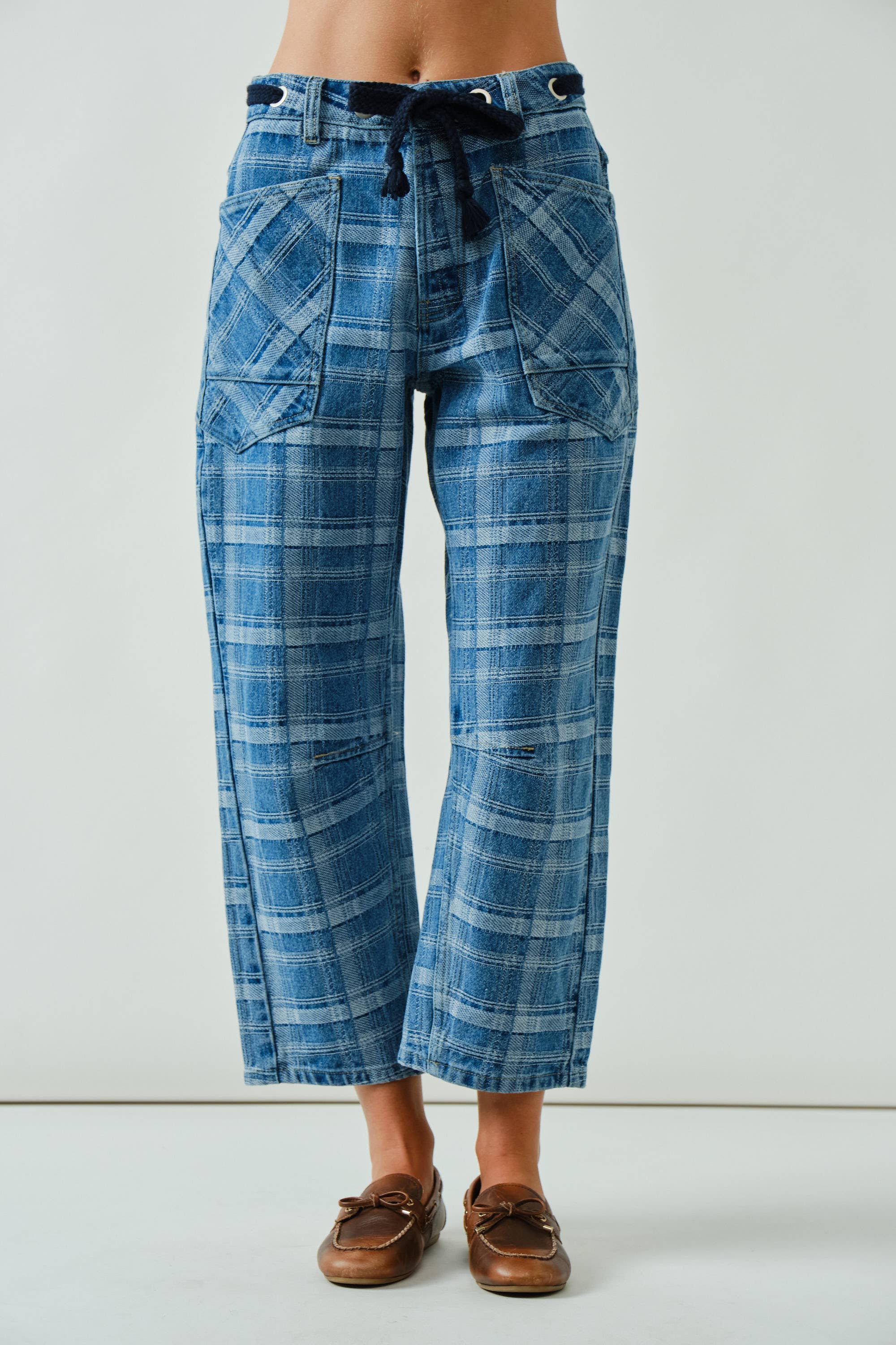 Blue plaid pants worn by a person on a white background