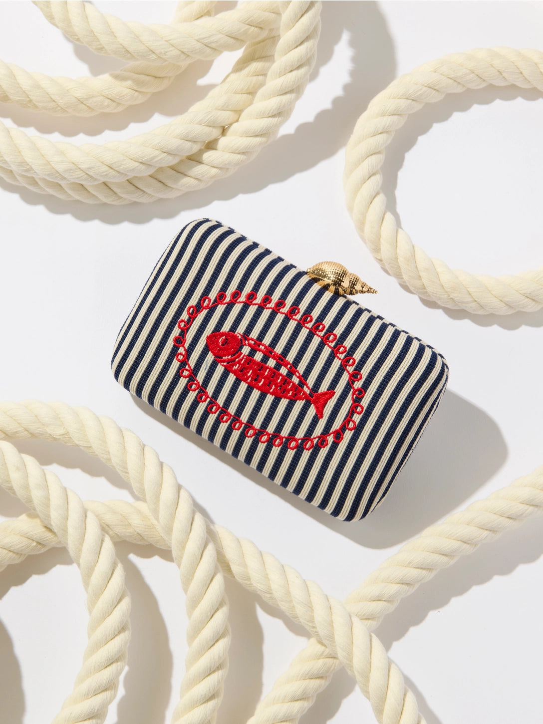 Striped pouch with embroidered design on a rope background