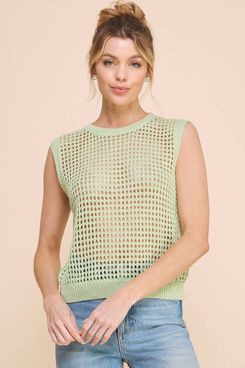 Woman wearing a light green sleeveless knitted top against a beige background