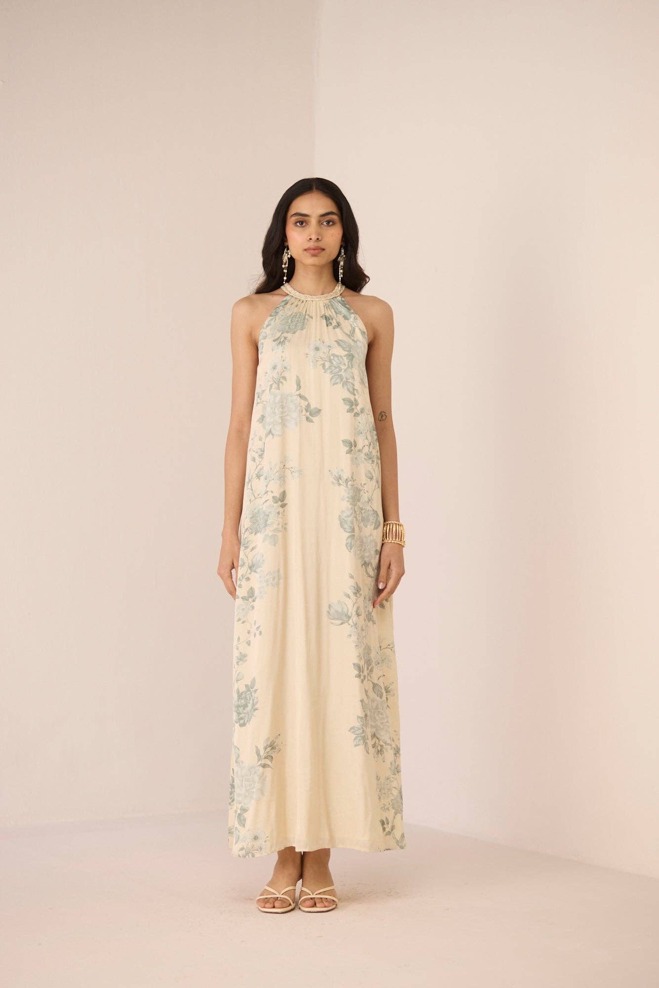 Woman wearing a floral dress on a plain background