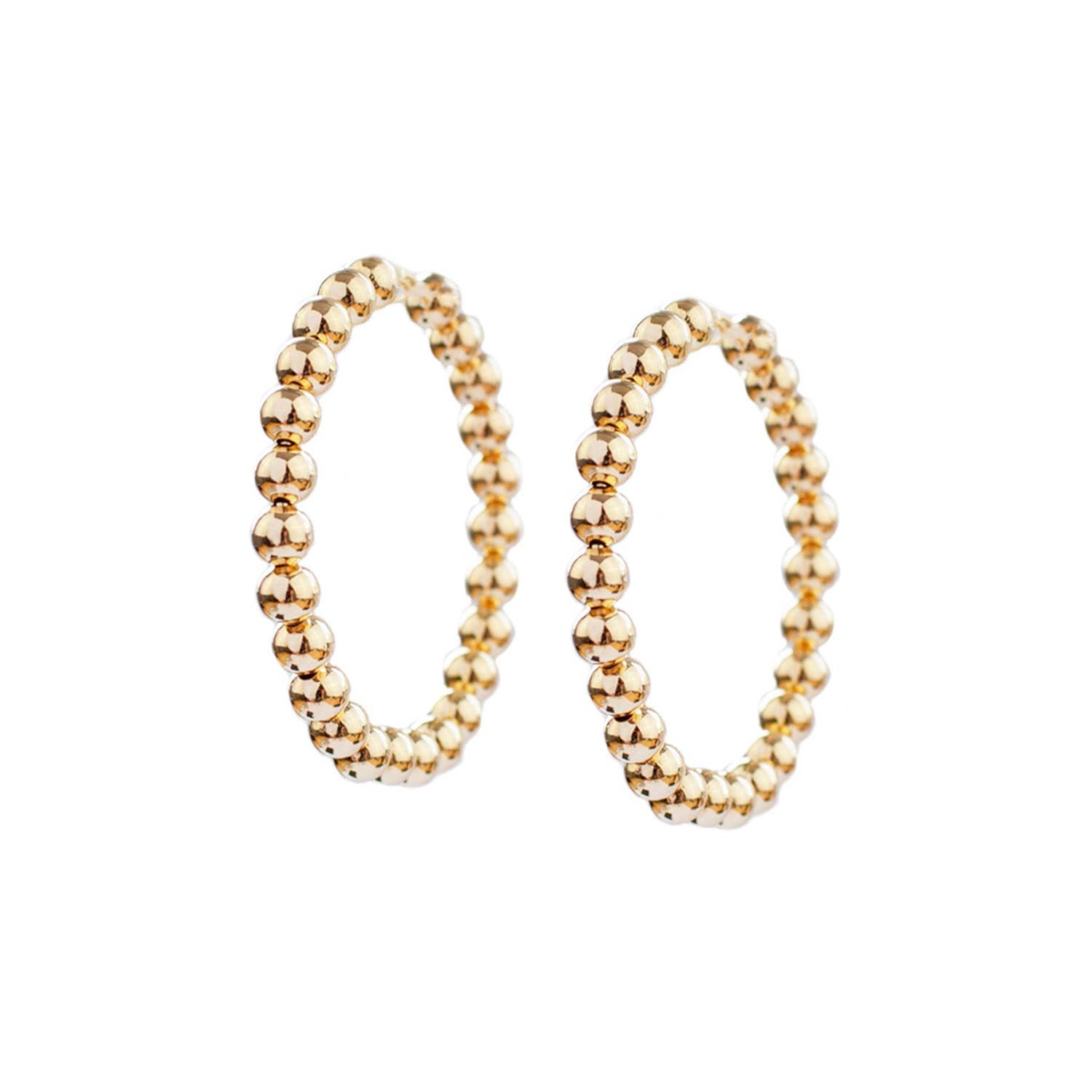 Gold beaded hoop earrings on a white background