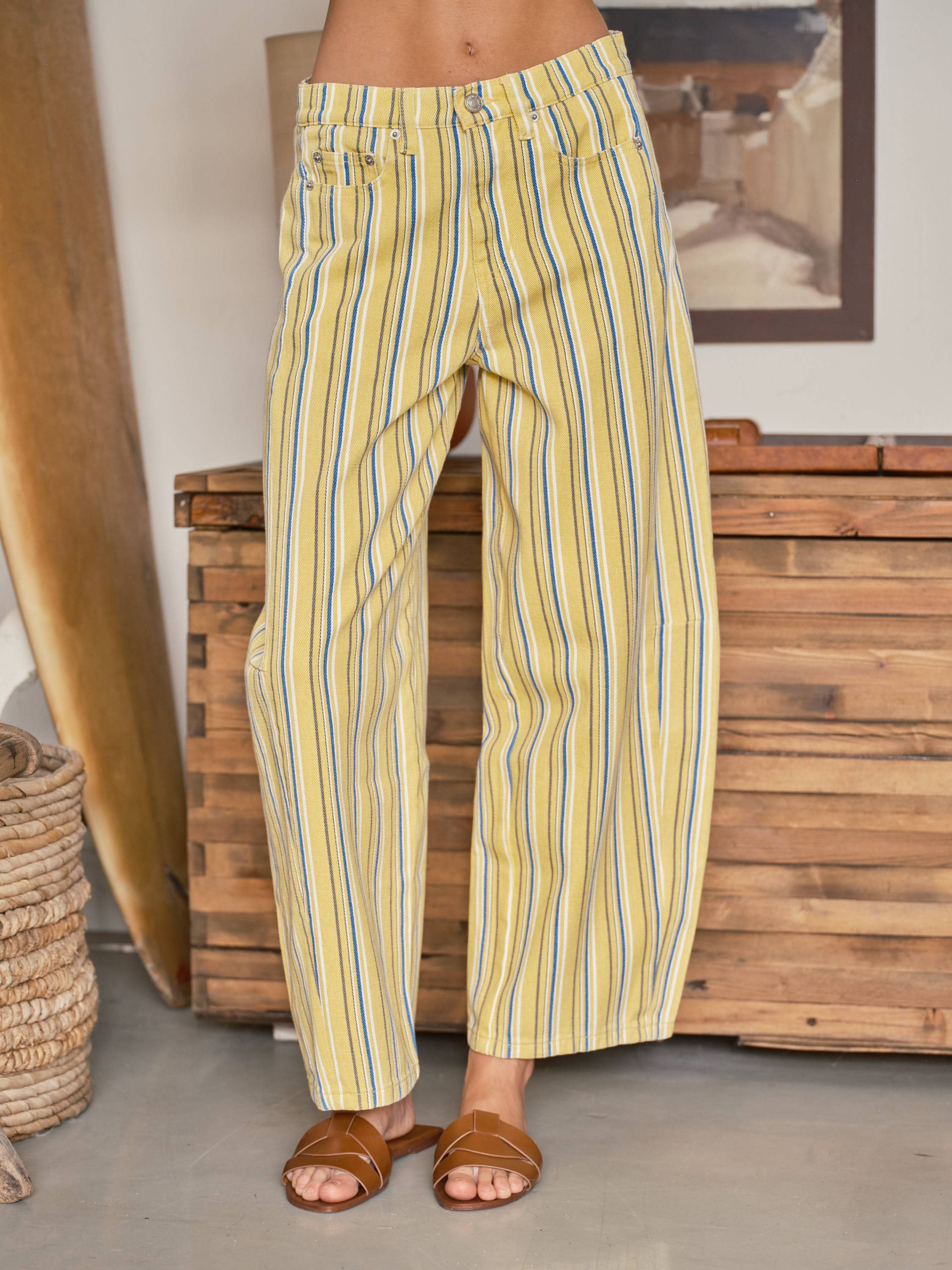 Yellow and blue striped pants worn by a person indoors.
