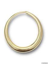 A gold-colored textured hoop earring with a ribbed, snake-like pattern, shown on a plain white background with a soft shadow.