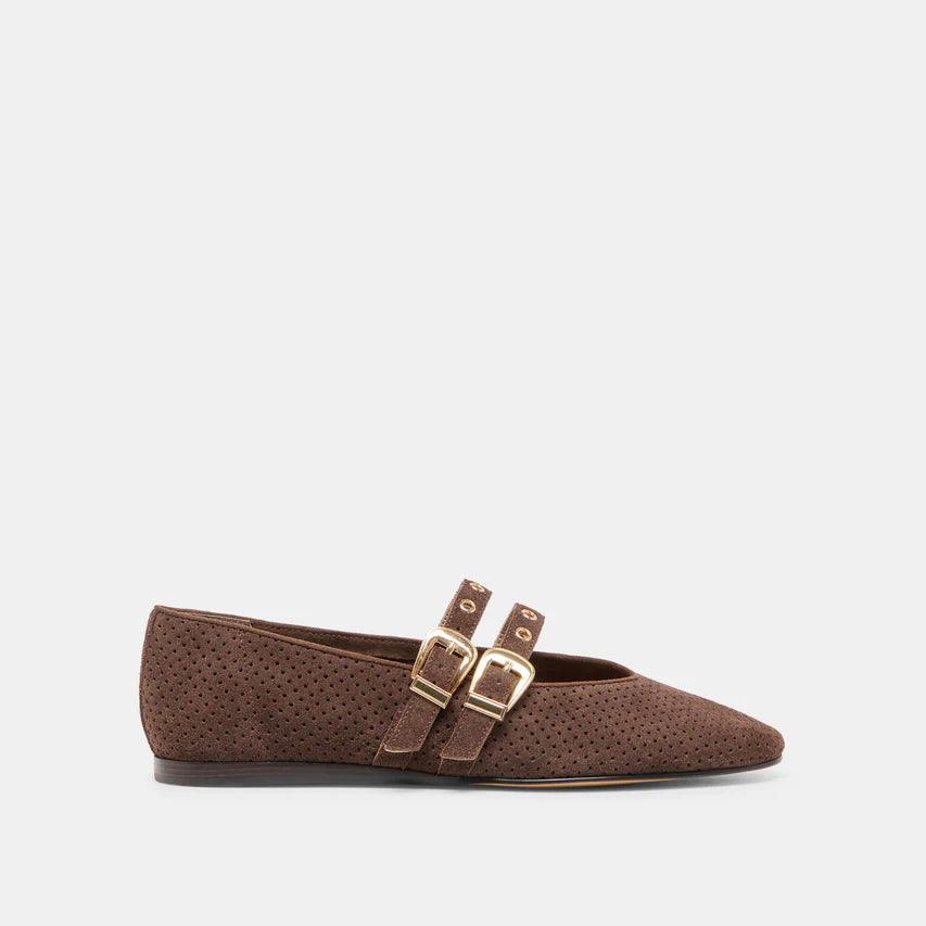 Brown flat shoe with gold buckles on a light gray background