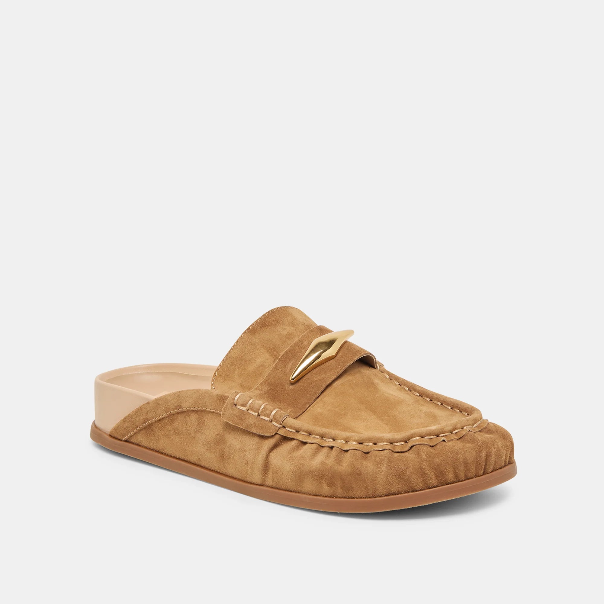 Tan suede slipper with a decorative strap on a white background