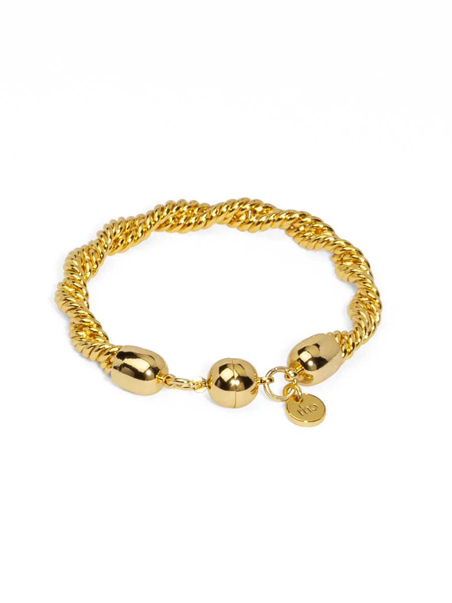 Gold chain bracelet with spherical beads on a white background