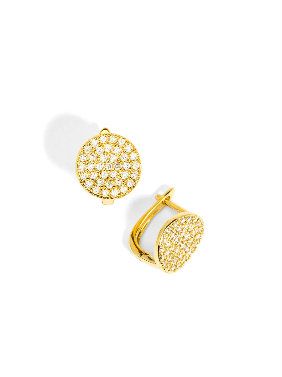 Gold earrings with white stones on a white background