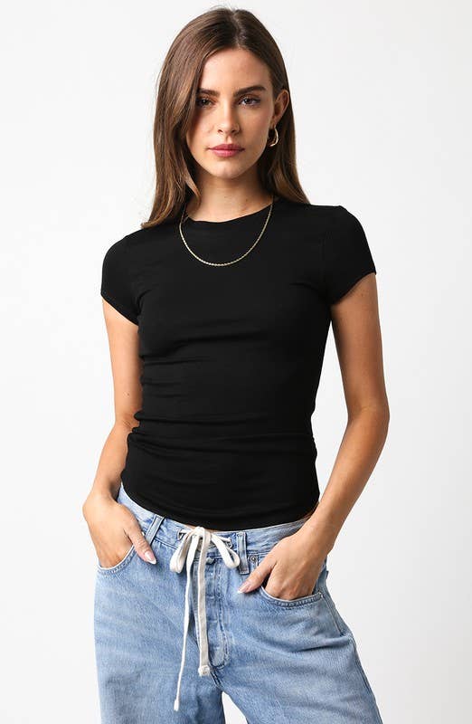 Woman wearing a black t-shirt and blue jeans on a white background
