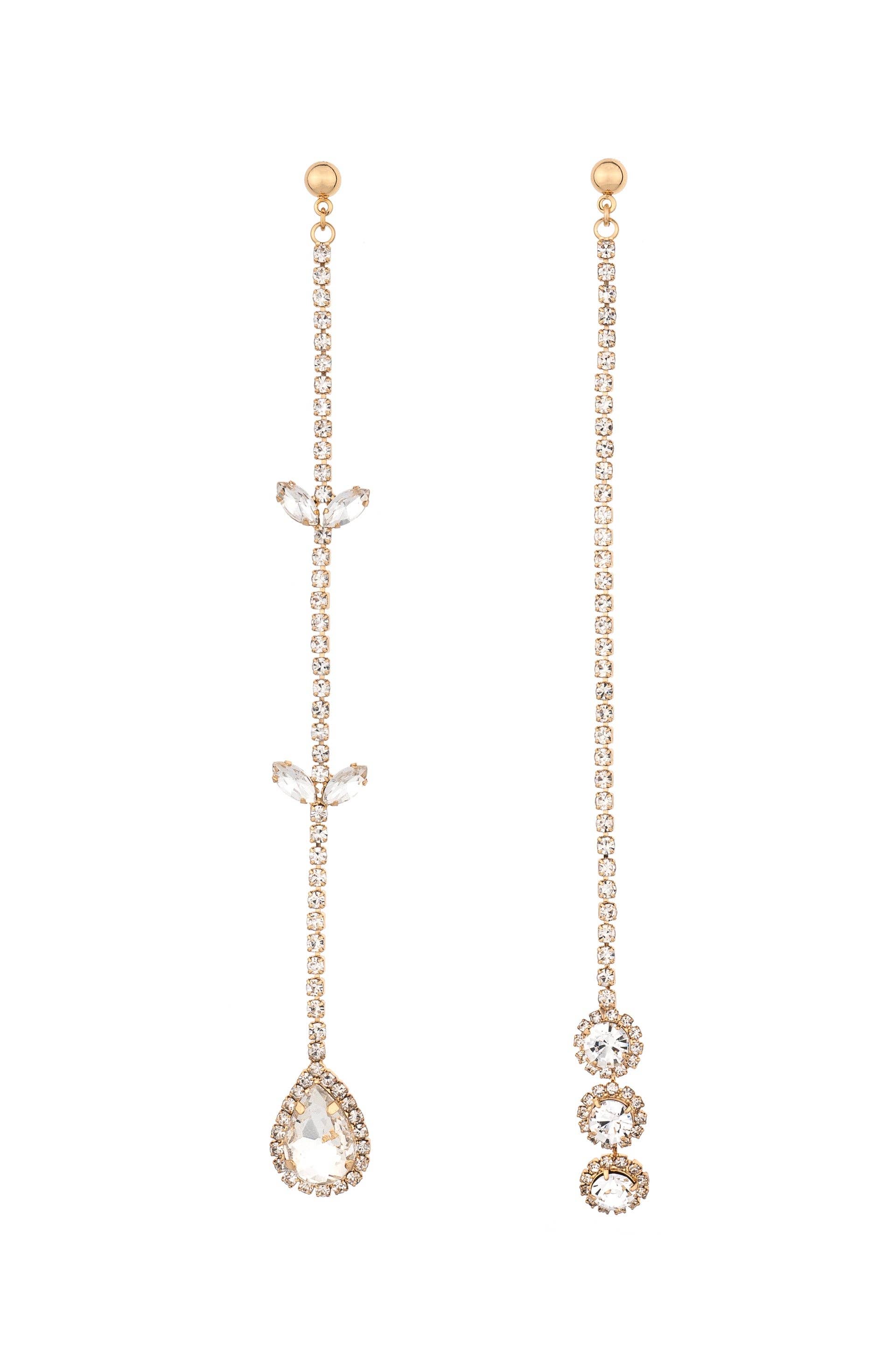 Pair of rose gold earrings with teardrop-shaped gemstones on a white background