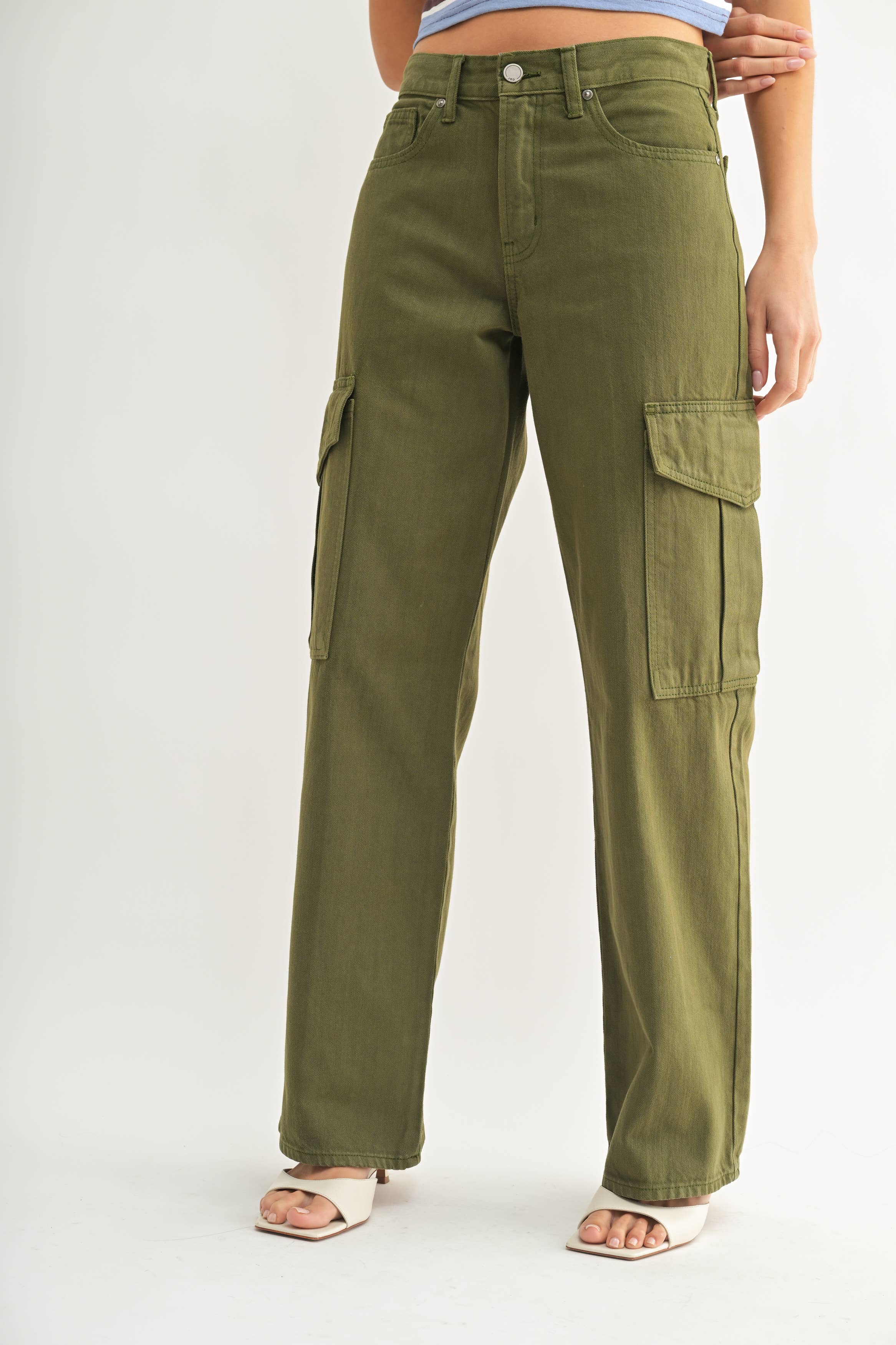 Green cargo pants worn by a person on a white background