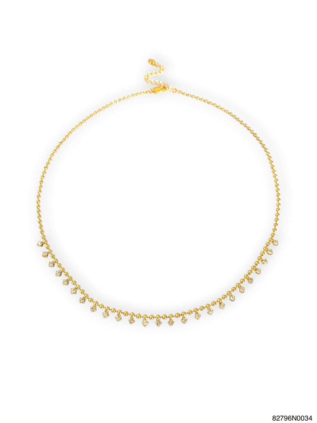 A delicate gold chain necklace with a row of small teardrop-shaped clear stones along the front, displayed on a clean white background.