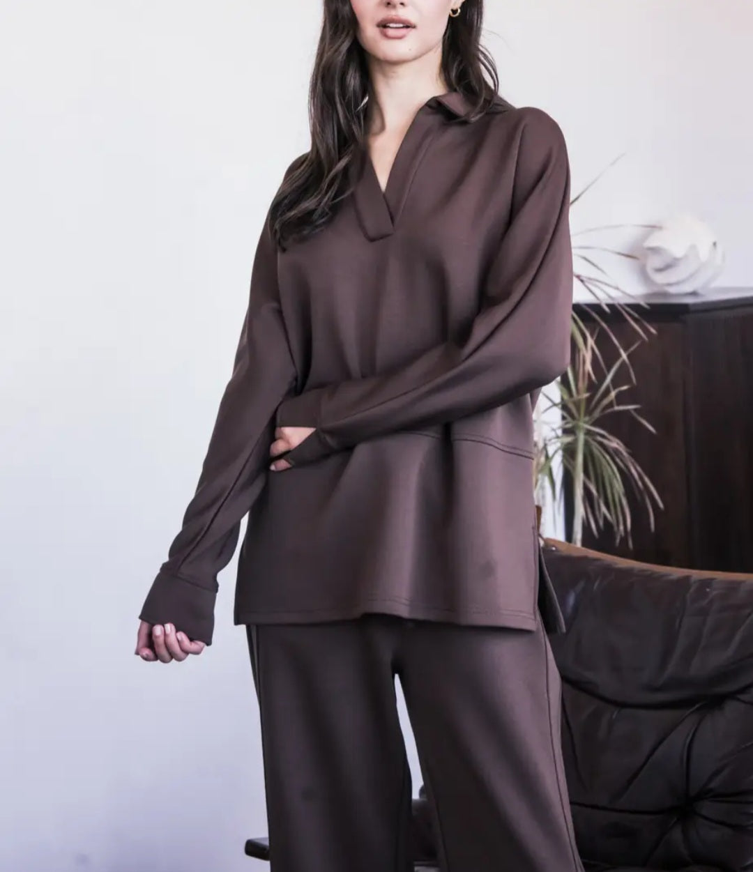 Person wearing a brown outfit with a plain background
