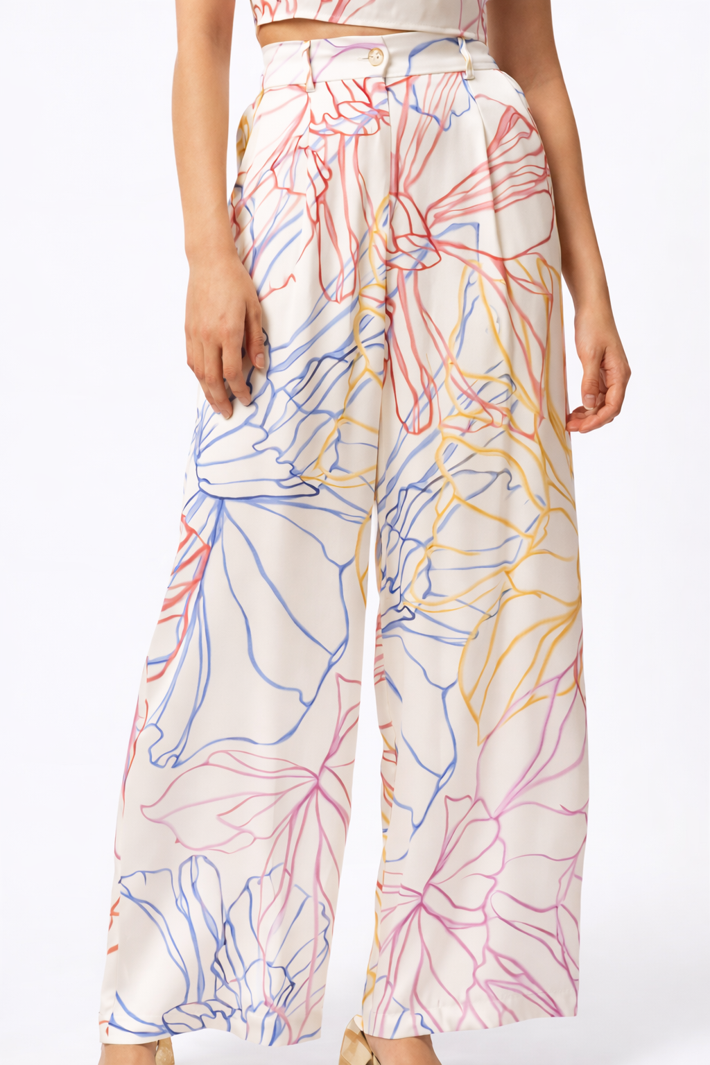 Colorful floral-patterned pants worn by a person on a white background