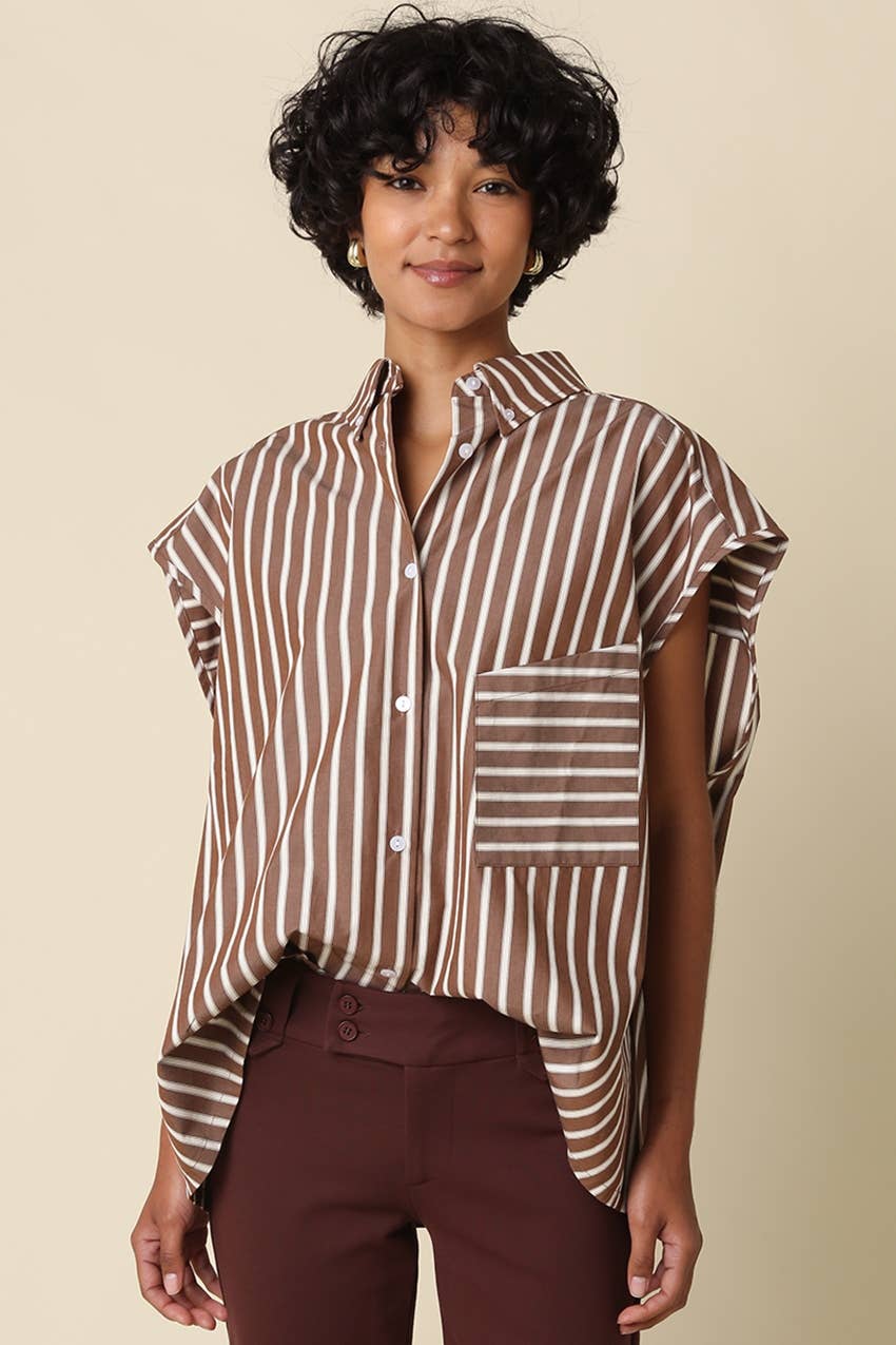 Woman wearing a brown and white striped shirt with a beige background