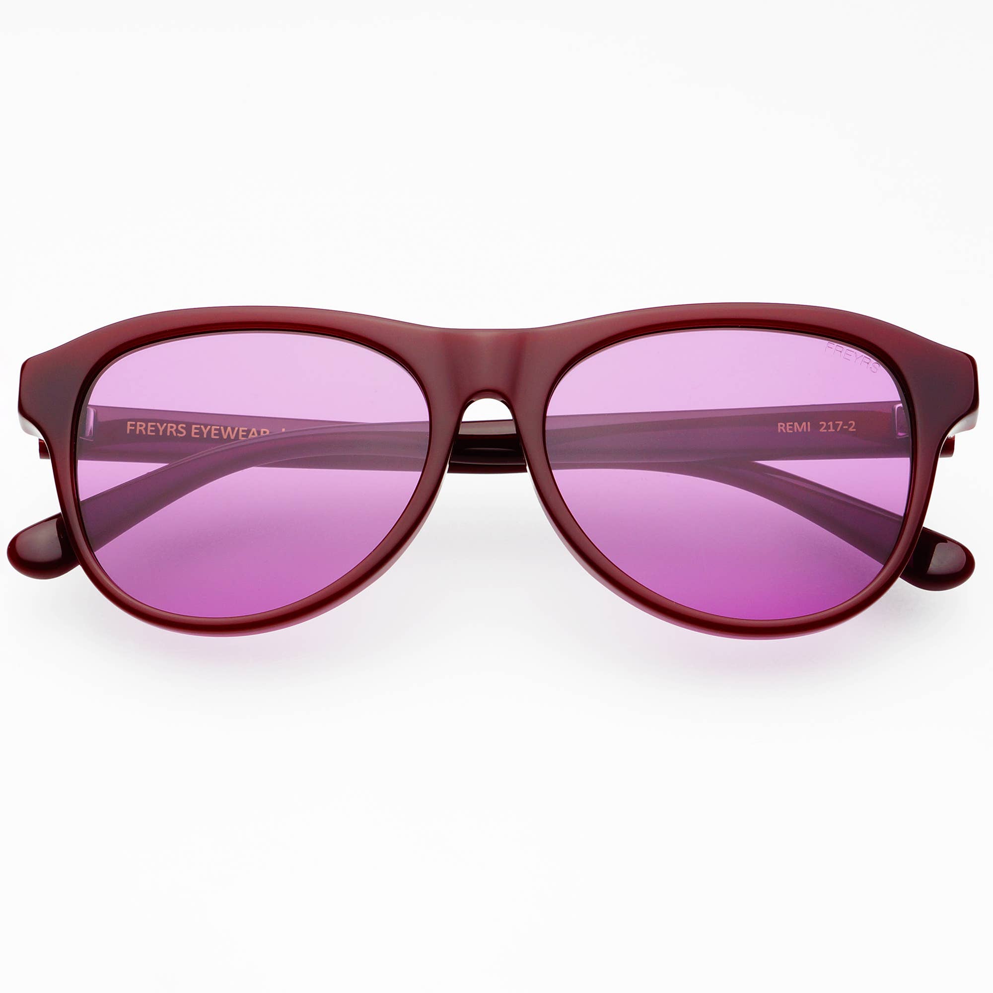 Sunglasses with pink lenses and a dark brown frame on a white background
