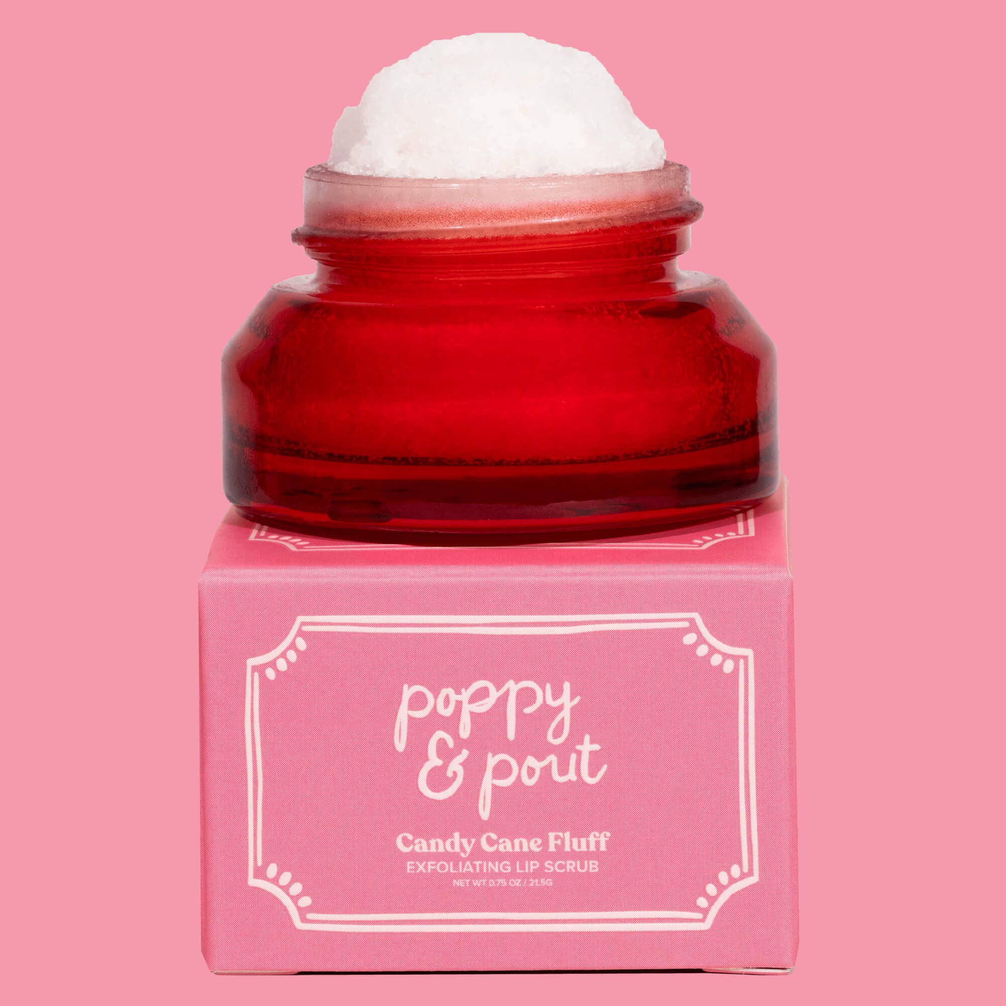 Red jar of 'poppy & pout' candy cane fluff on a pink background