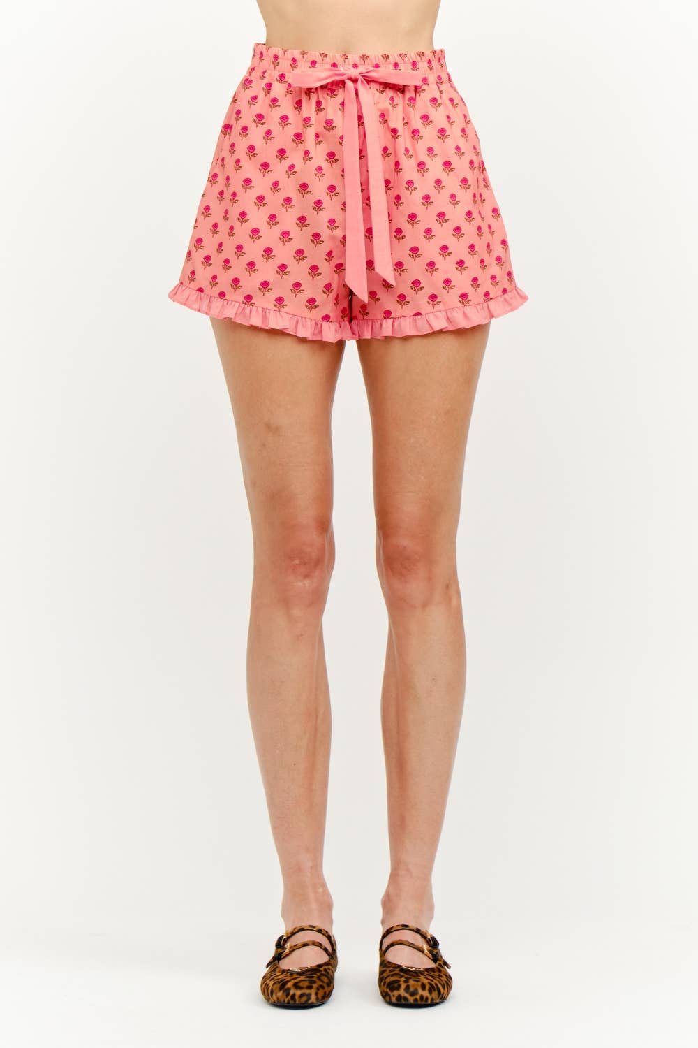 Pink shorts with a pattern worn by a person on a white background