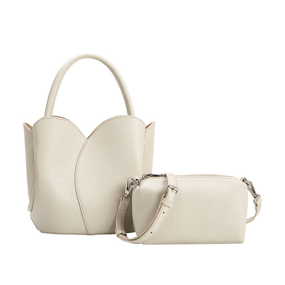Set of two cream handbags on a white background