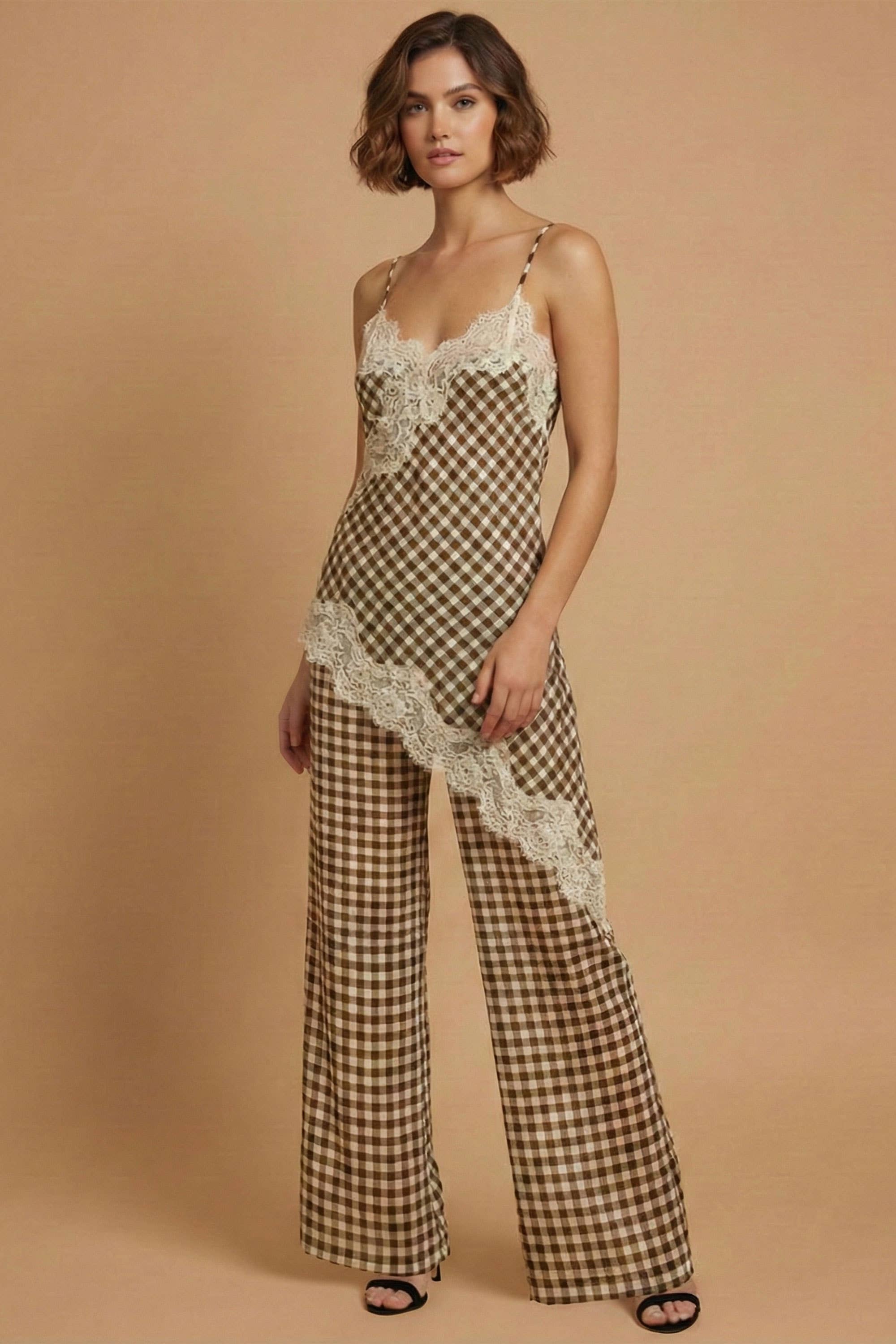 Woman wearing a checkered jumpsuit with lace details on a beige background