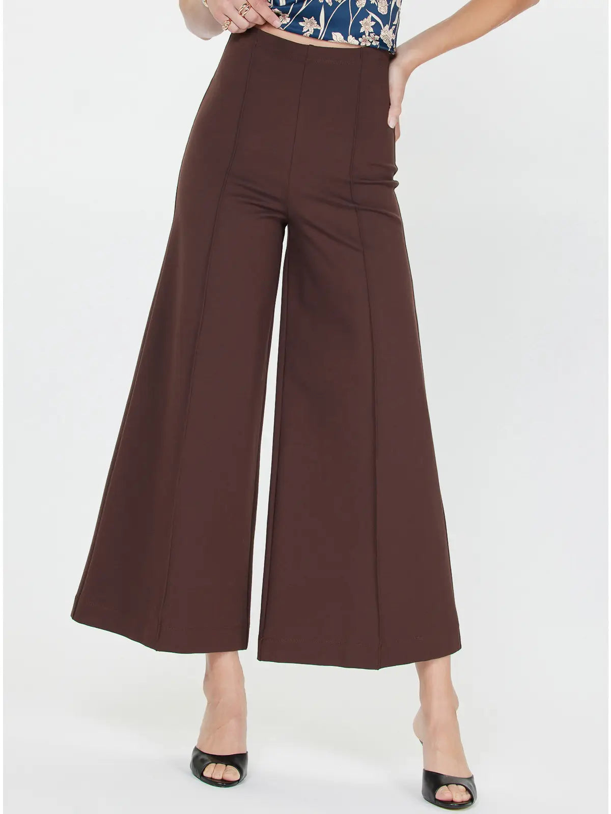 Brown wide-leg pants worn by a person on a white background
