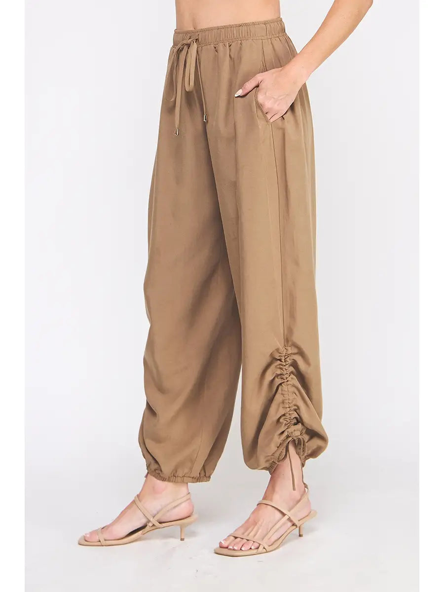Brown wide-leg pants worn by a person on a white background