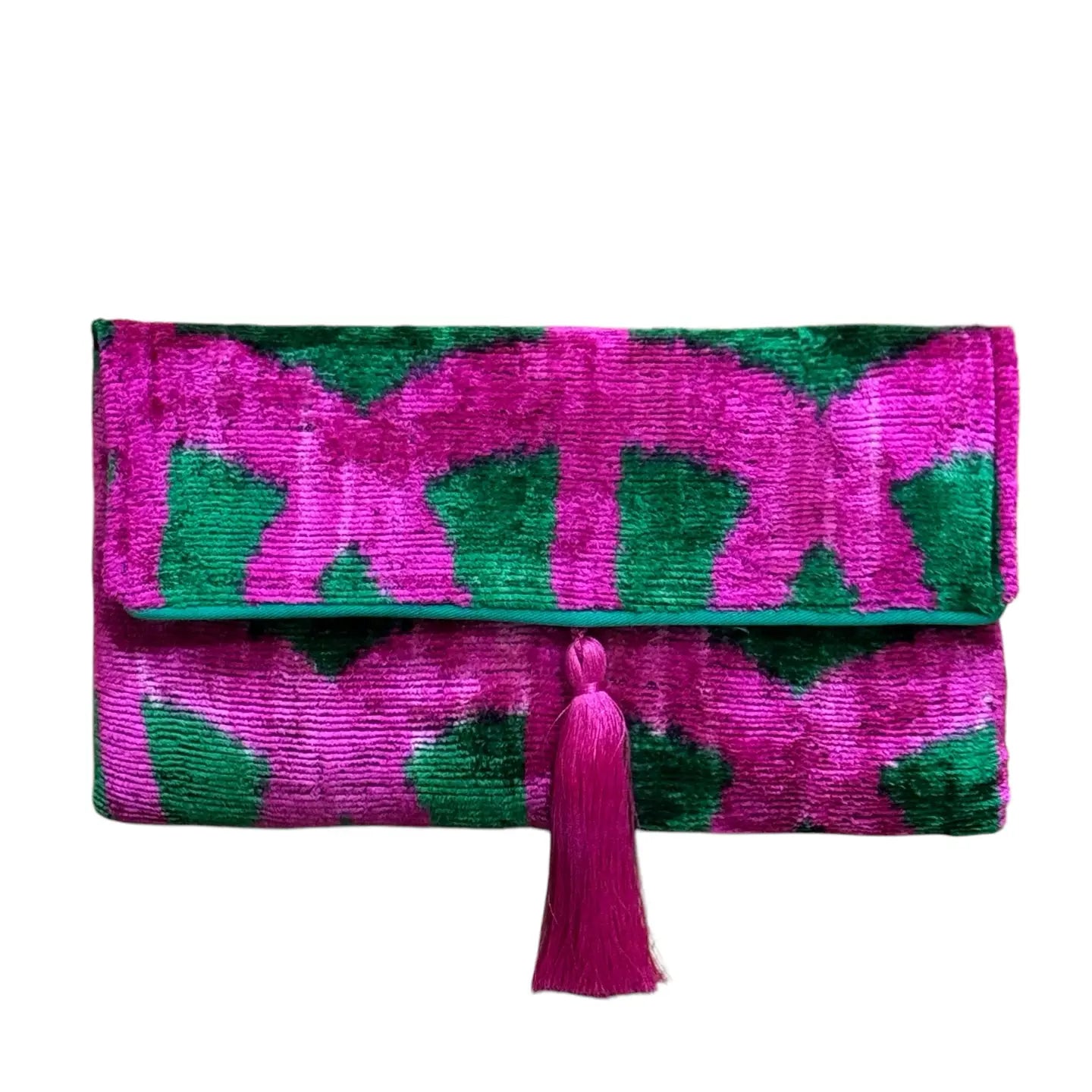 Clutch bag with pink and green pattern and tassel on a white background