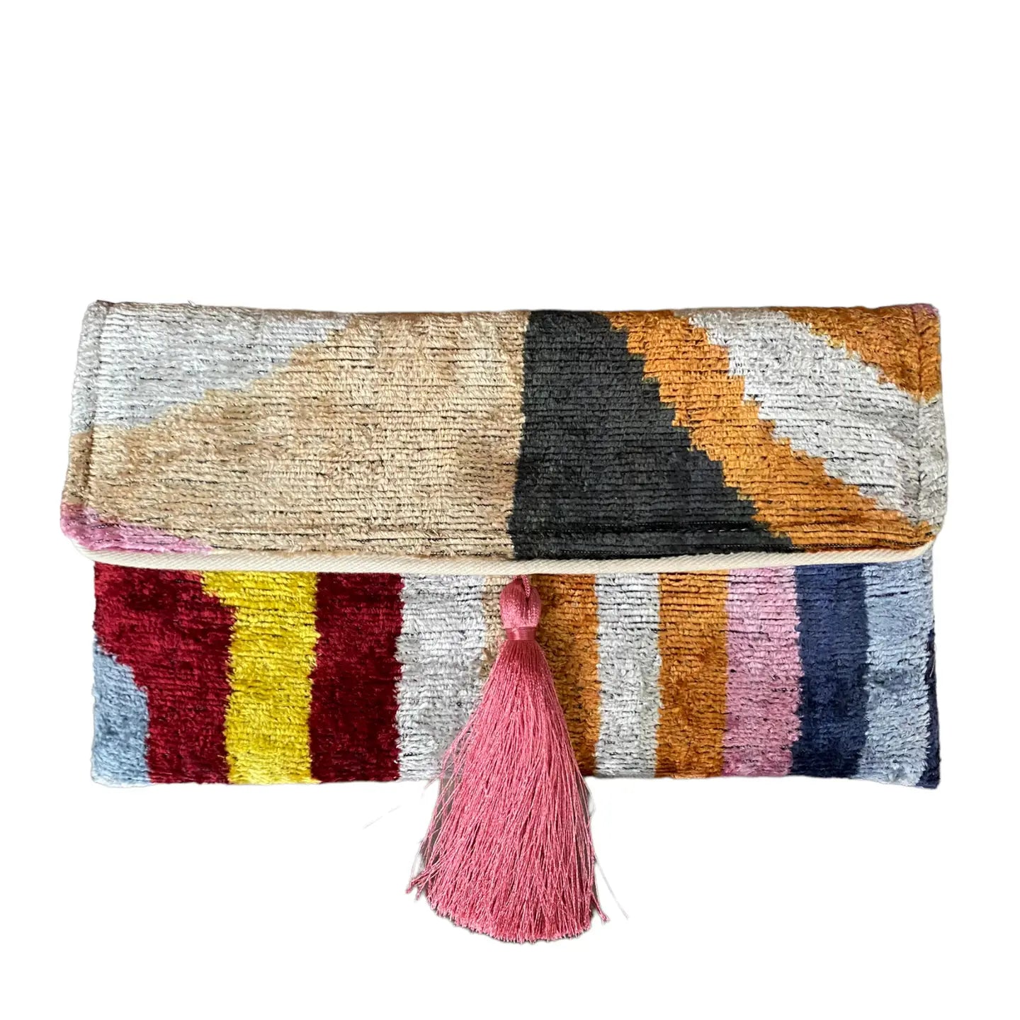 Colorful clutch bag with geometric pattern and pink tassel on a white background