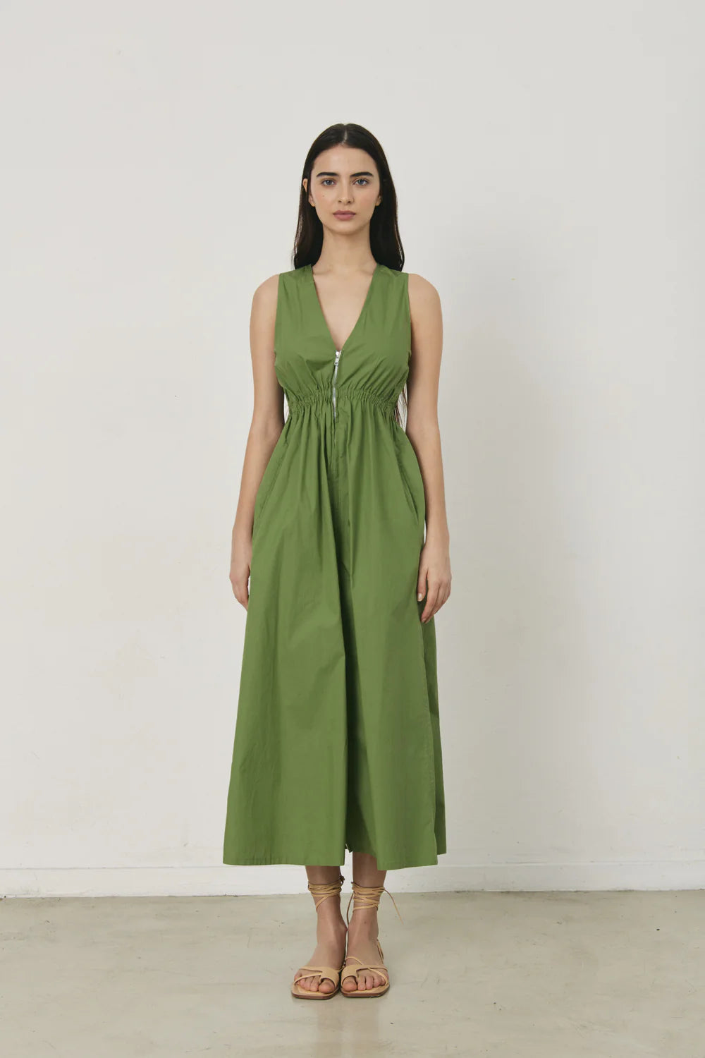 Woman wearing a green dress against a white background