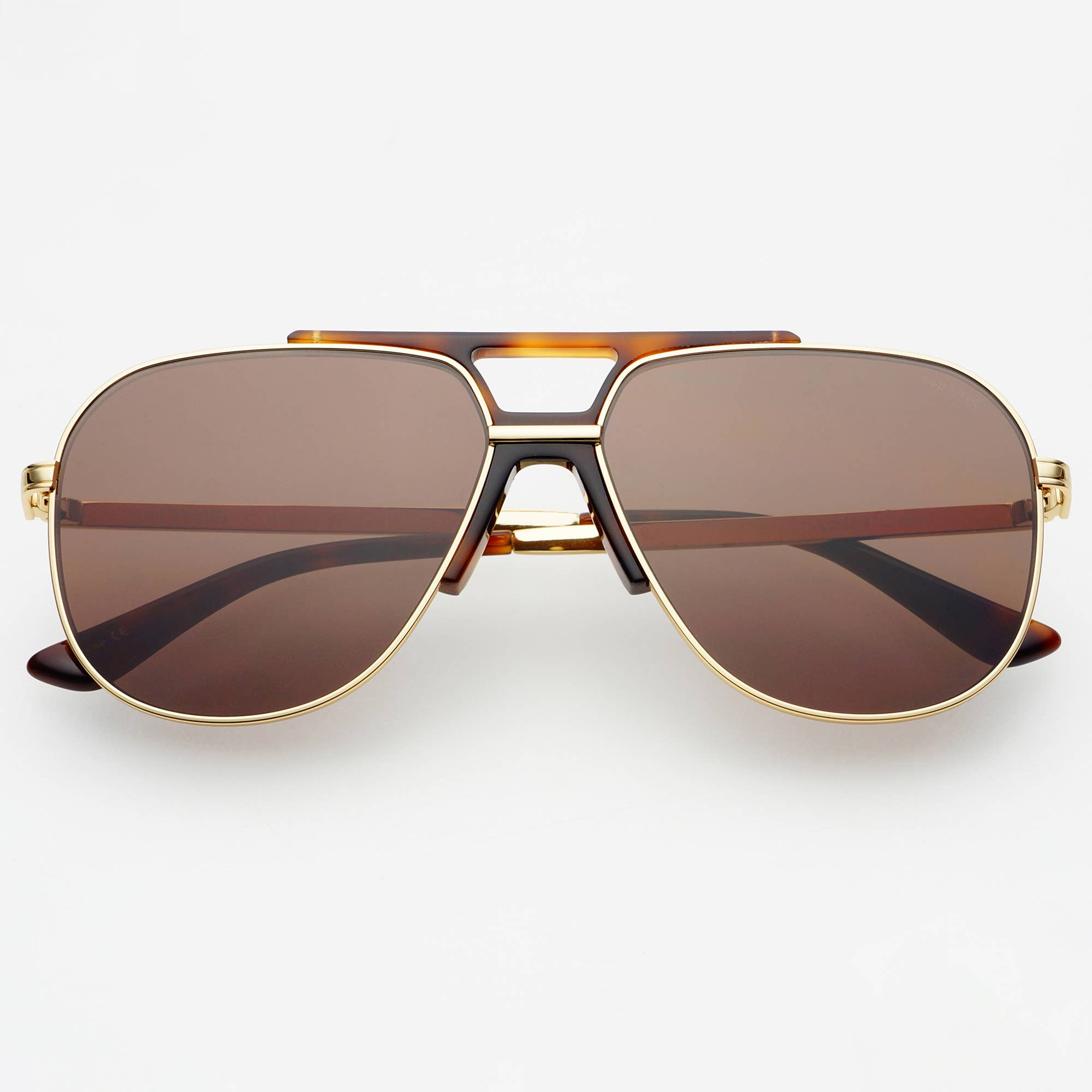 Aviator sunglasses with gold frame and brown lenses on a white background