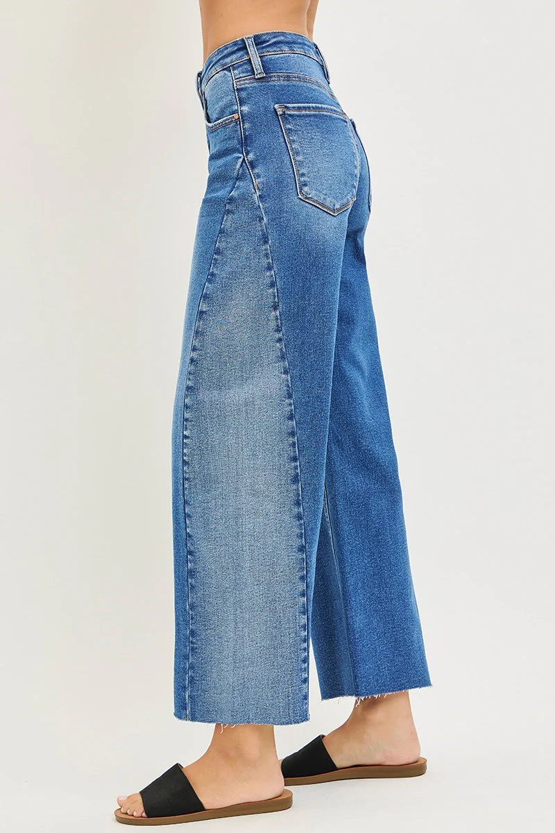 Blue jeans worn by a person on a white background