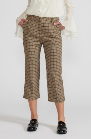 Person wearing plaid pants on a white background