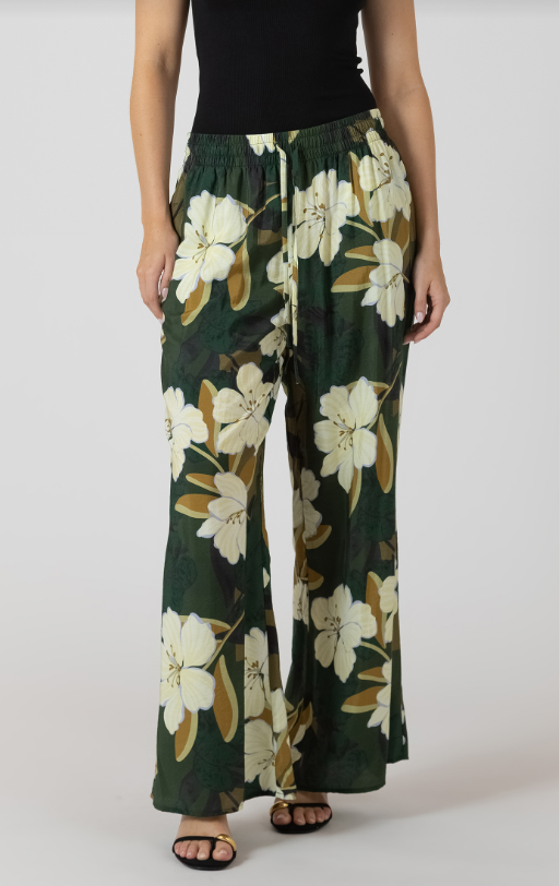 Person wearing floral pants on a plain background