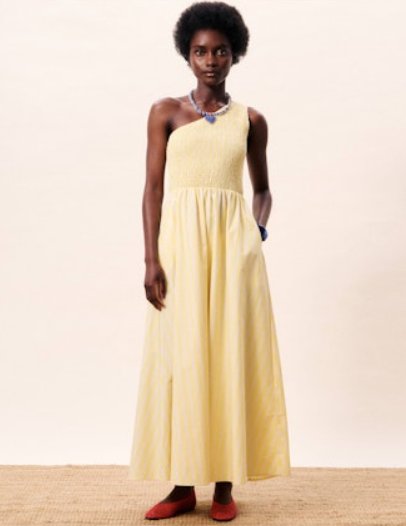 Woman wearing a yellow dress on a plain background