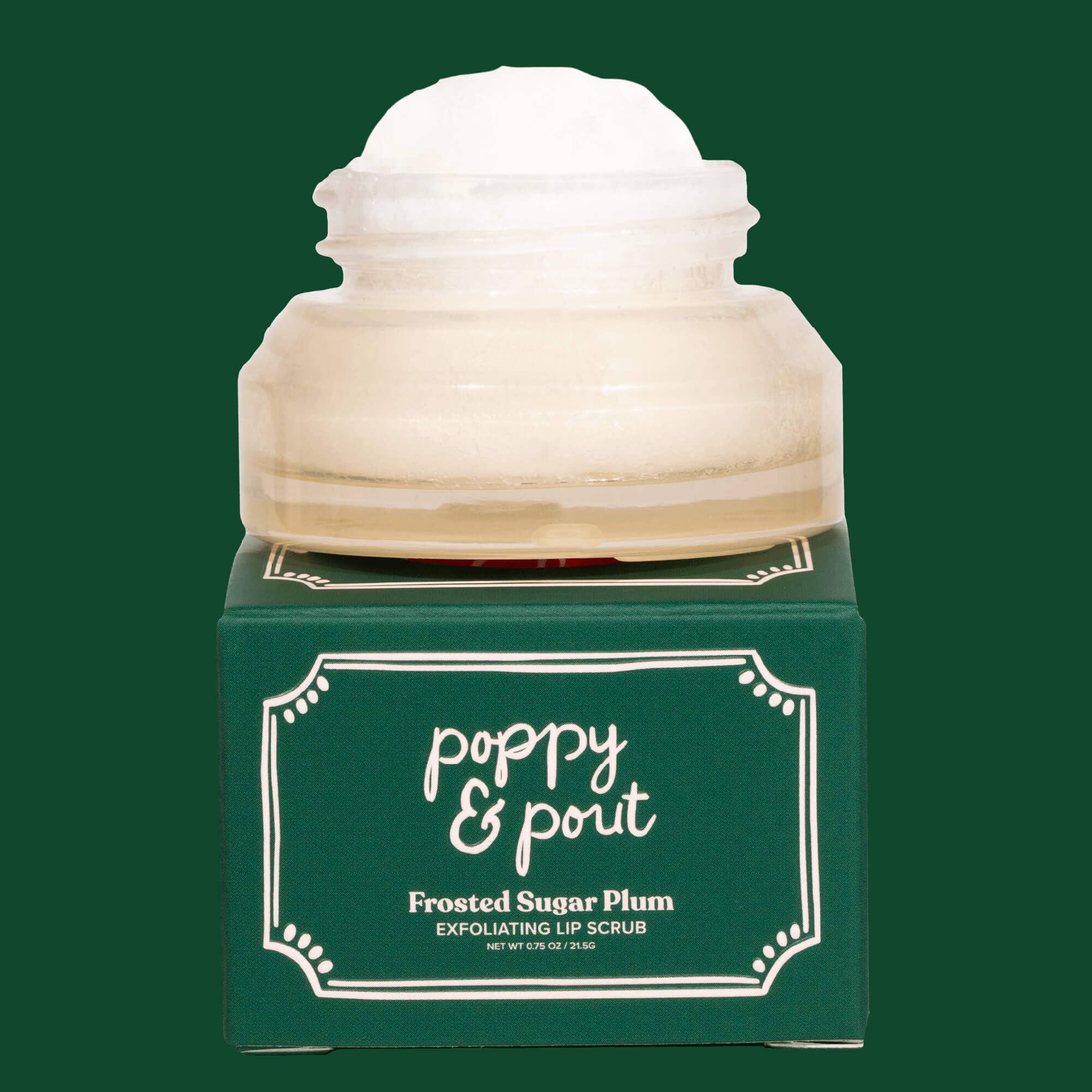 Lip scrub container with 'poppy & pout' branding on a green background