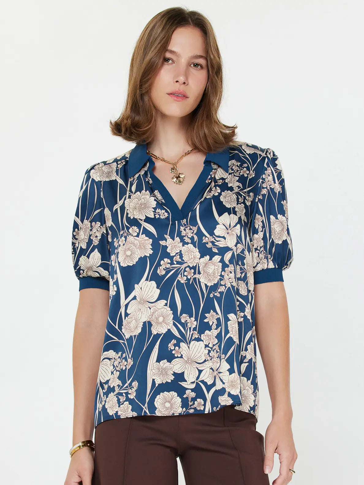 Woman wearing a blue floral blouse on a white background