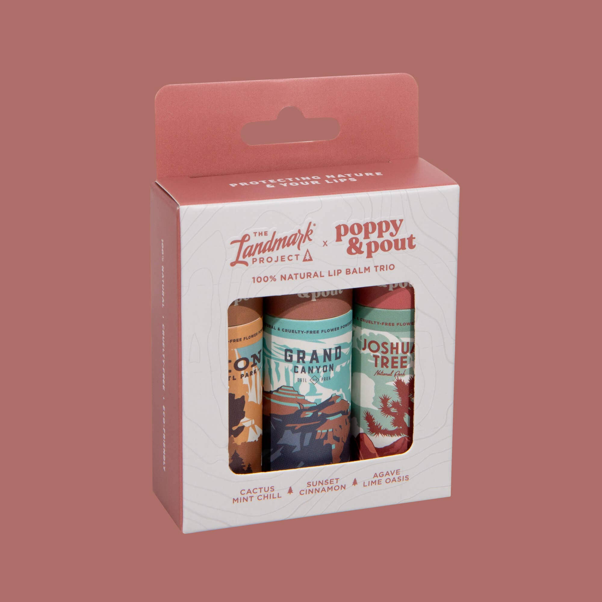 Packaging of Poppy & Pout lip balm trio with Landmark Project branding on a red background