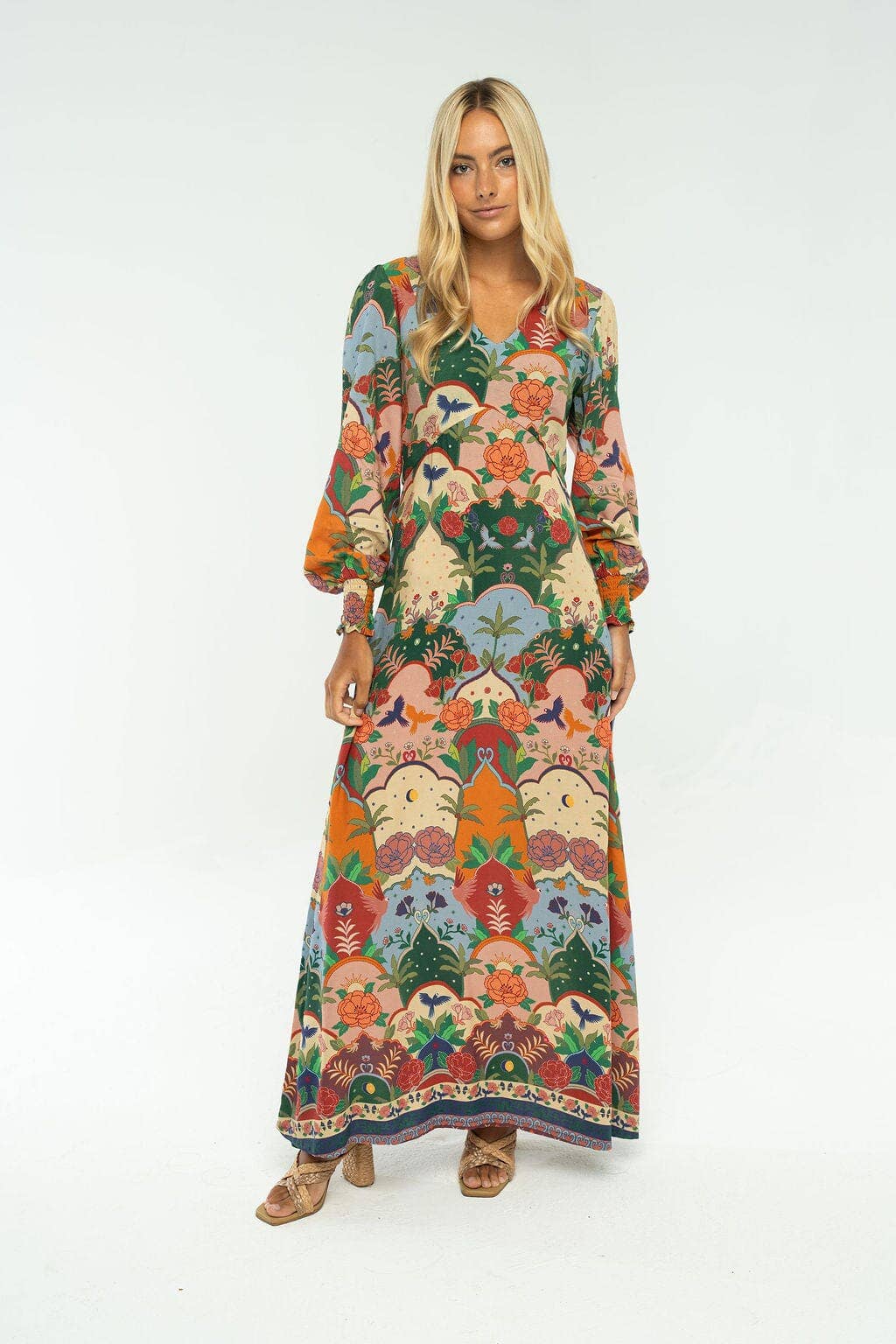 Woman wearing a colorful floral dress on a white background