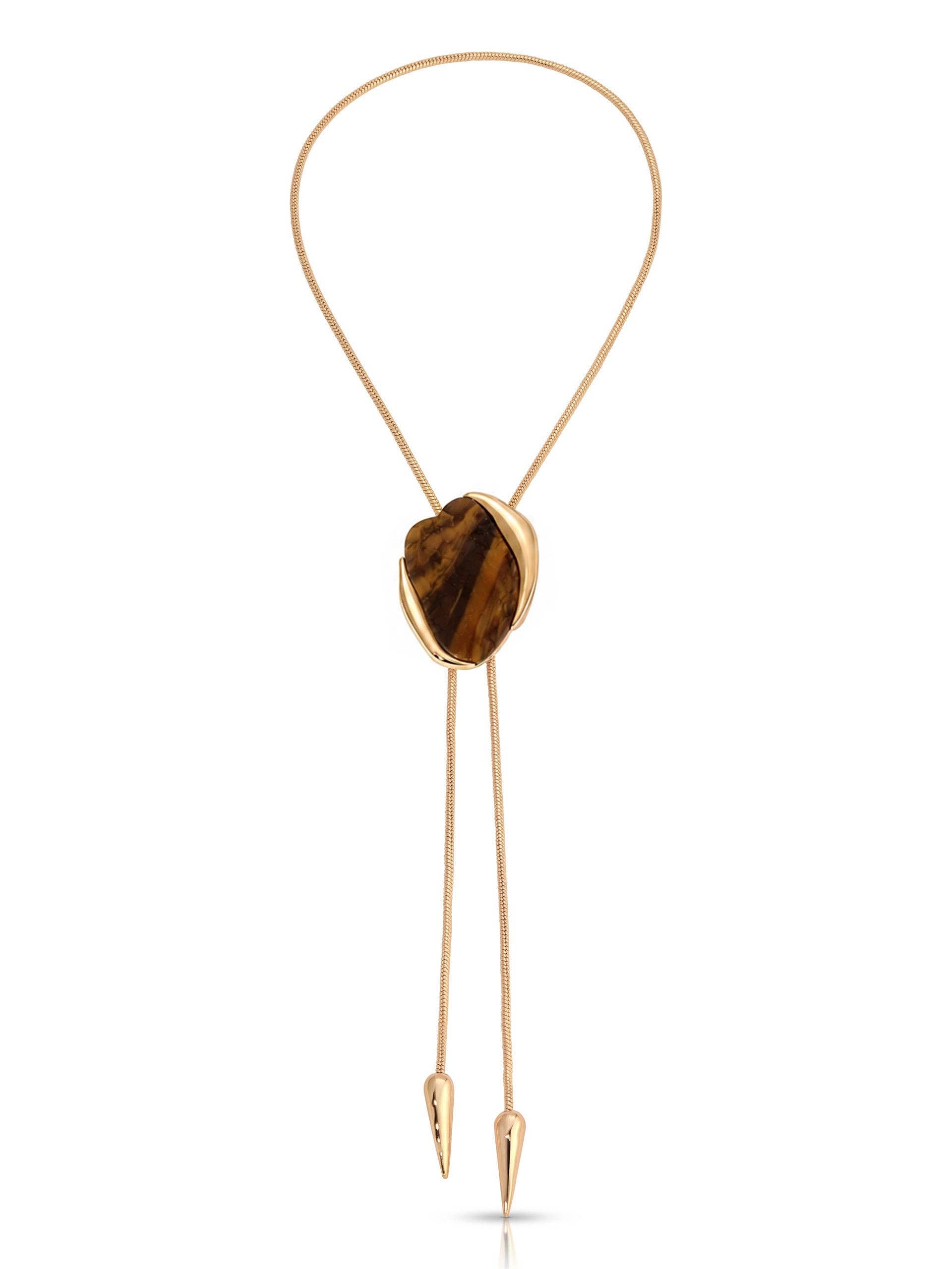 A gold-toned bolo tie necklace featuring a polished tiger's eye stone pendant, displayed on a clean white background.