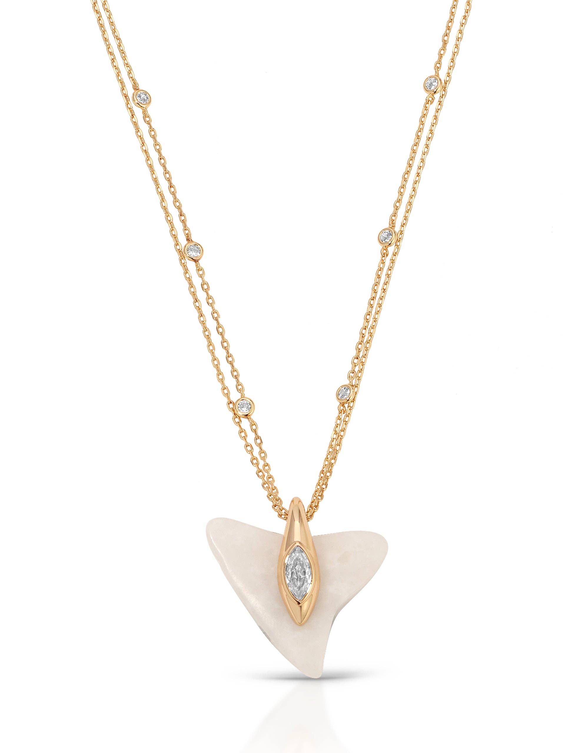 Gold necklace with a white pendant on a white background