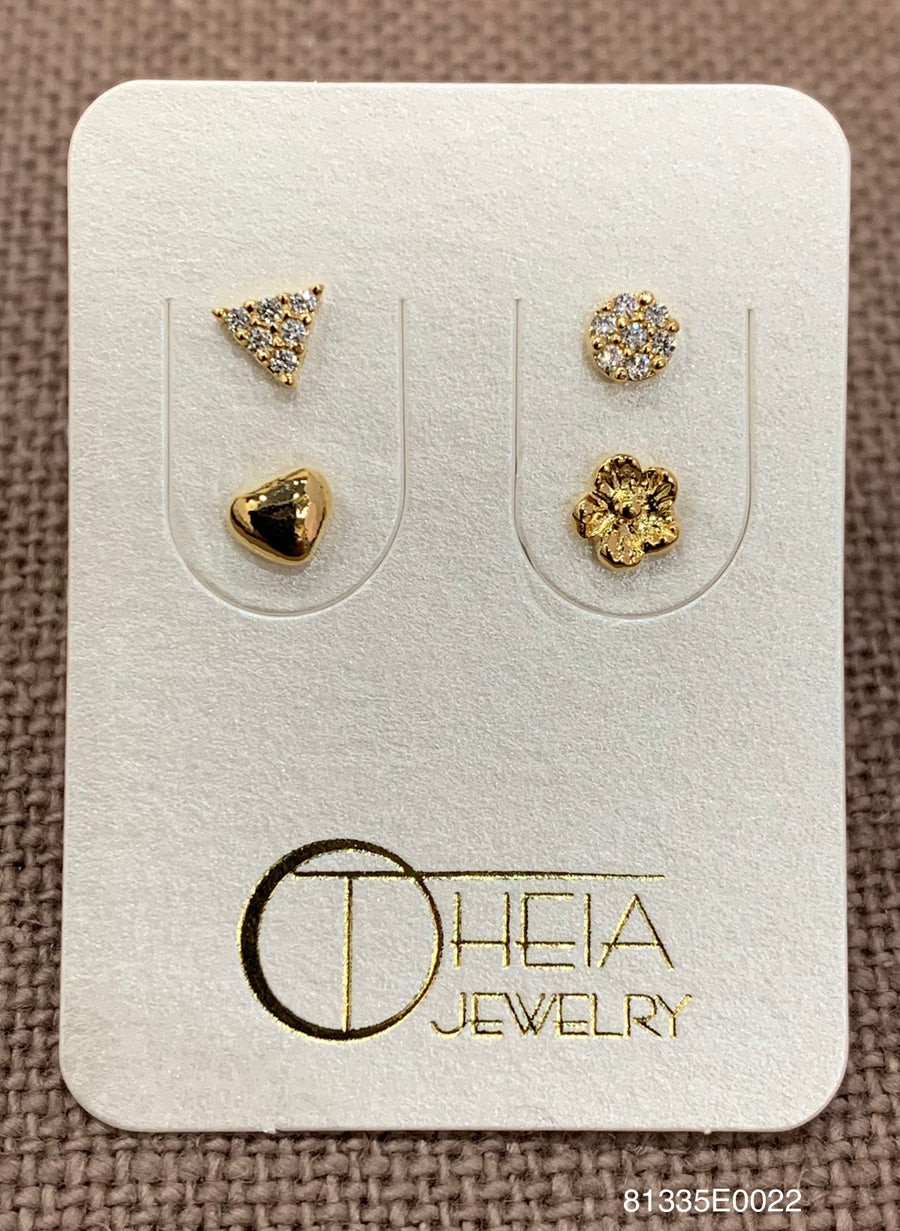 A pair of gold stud earrings displayed on a white jewelry card. The earrings include a small triangular crystal cluster, a heart-shaped crystal cluster with a black center, a round crystal cluster, and a flower-shaped crystal cluster.