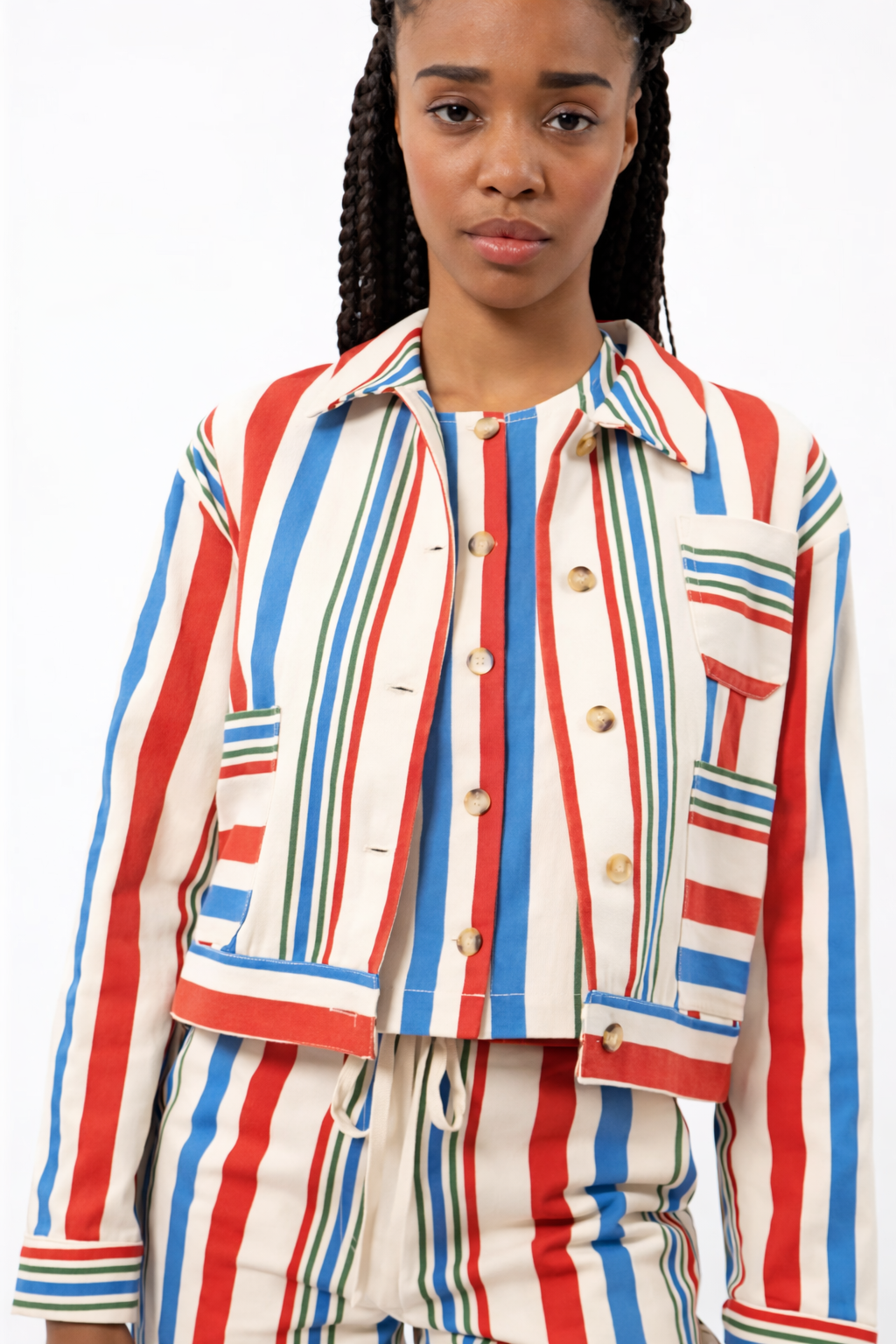 Woman wearing a colorful striped outfit on a white background