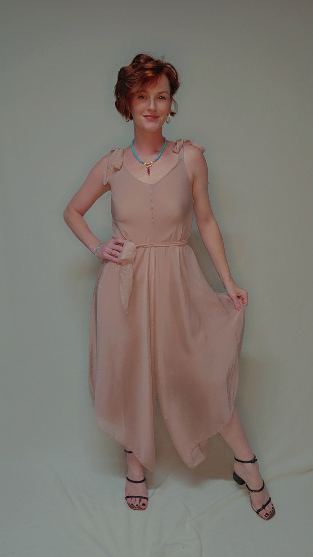 women in blush pink chiffon jumpsuit